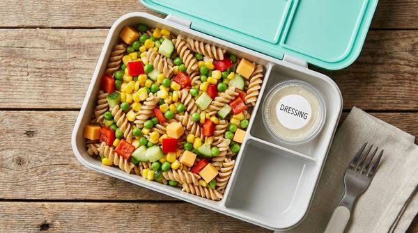 Kalter Nudelsalat mit Gemüse und Käse in der Brotdose, Dressing separat verpackt.