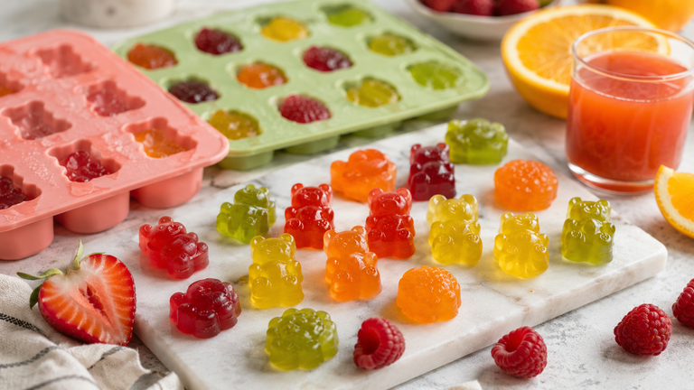 Bunte selbstgemachte Gummibärchen mit Fruchtsaft und Silikonformen